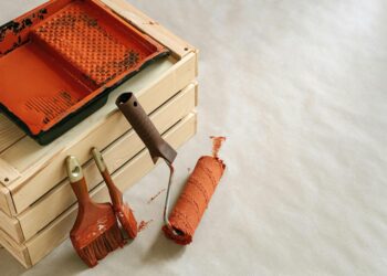 A collection of painting tools and supplies for home improvement projects, featuring brushes and a roller.