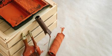A collection of painting tools and supplies for home improvement projects, featuring brushes and a roller.