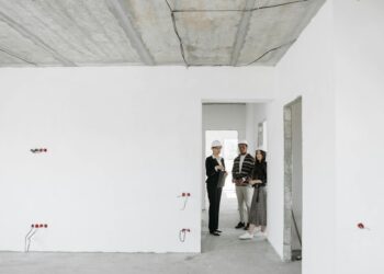 Group of diverse professionals discussing building plans on site.
