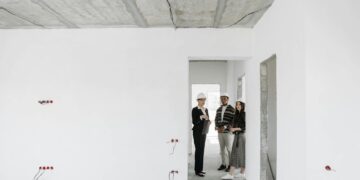 Group of diverse professionals discussing building plans on site.