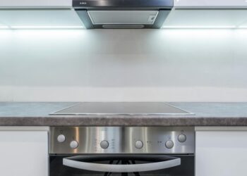 A sleek, modern kitchen with steel appliances and minimalist design.