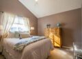 Bright and inviting bedroom interior with neutral tones and elegant decor.