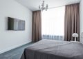 A minimalist bedroom featuring sleek furniture and a modern interior design.