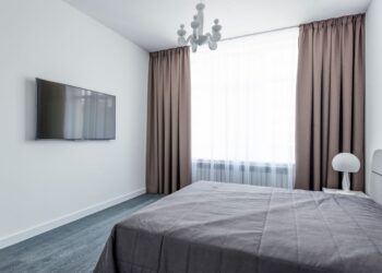 A minimalist bedroom featuring sleek furniture and a modern interior design.
