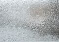 A detailed view of a frosted glass surface, capturing the icy texture and winter ambiance.