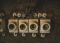 Close-up of vintage ceramic electrical switches, showcasing industrial decay and retro design.