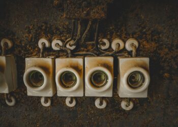 Close-up of vintage ceramic electrical switches, showcasing industrial decay and retro design.