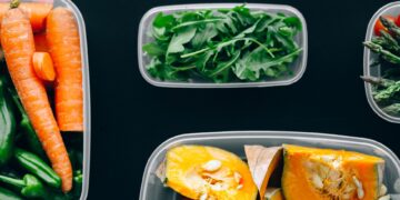 Healthy vegetables stored in plastic containers for fresh and nutritious meals.
