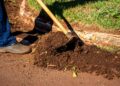 Close-up of gardener working soil using a hoe in Londrina, Brazil.